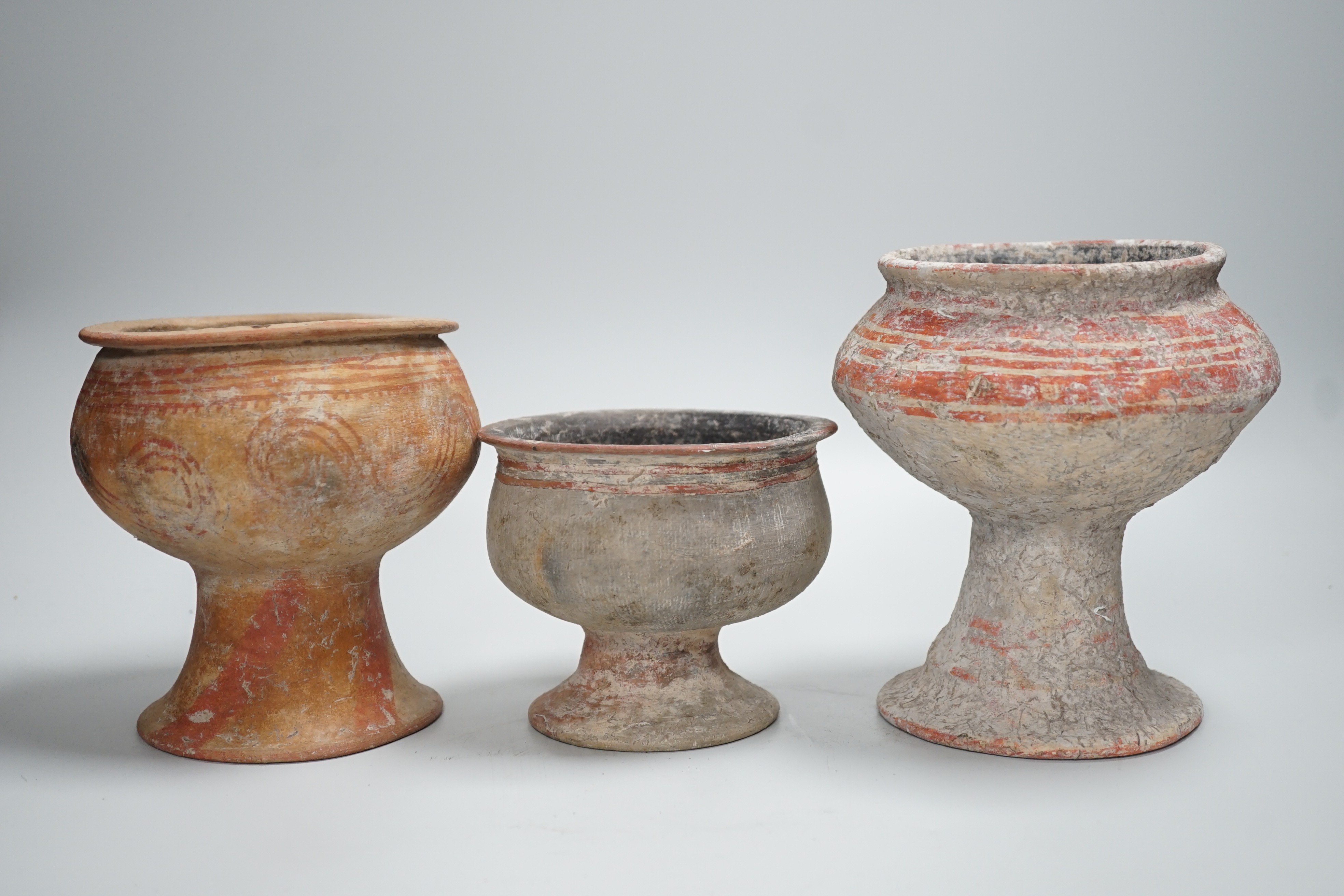 Three Ban Chiang pottery pedestal vessels, Thailand, 300 BCE–200 CE, tallest 16cm